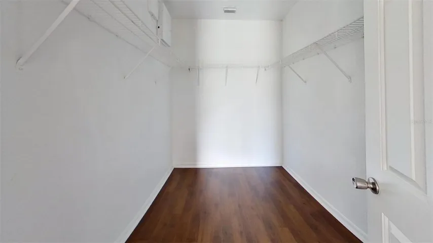 Primary bedroom walk-in closet
