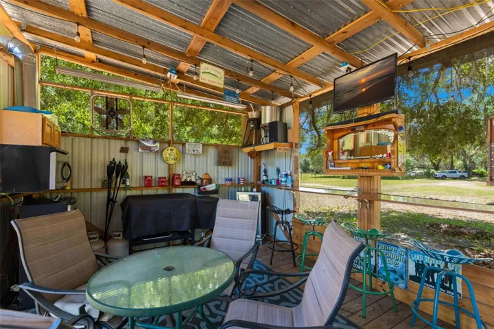 COOK SHED Included are a fridge, smoker, table and chairs.