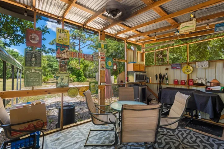 COOK SHED Included are a fridge, smoker, table and chairs.