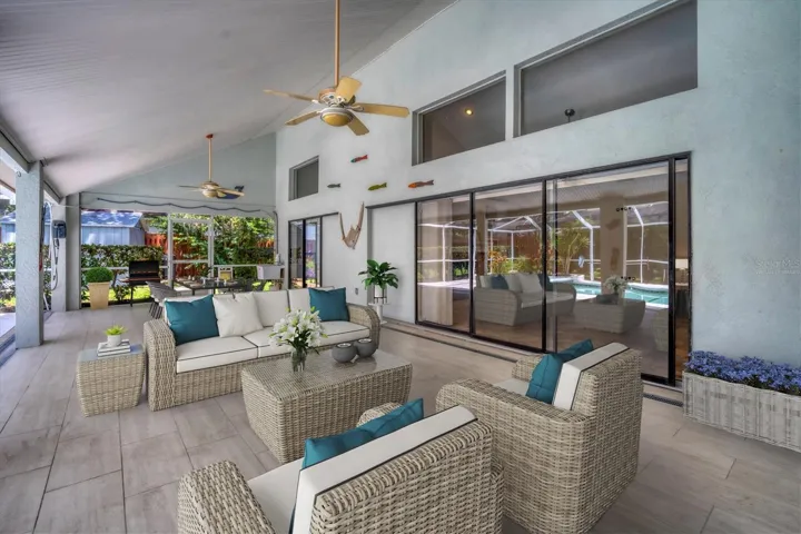 Virtually Staged.  Super sized covered lanai with pocket sliders is large enough to create two distinct living spaces.