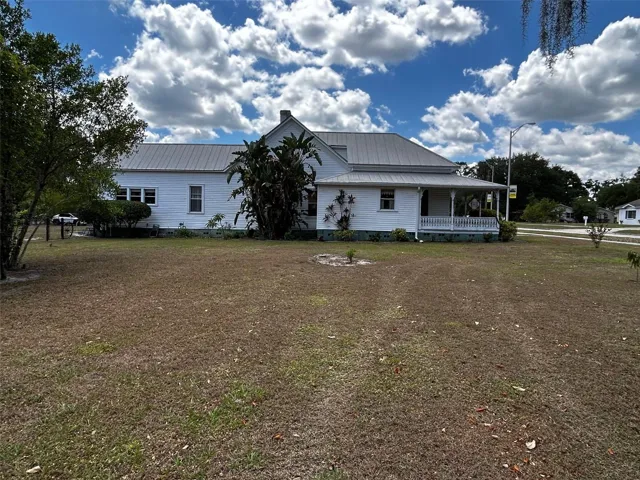 East side of house and fruit trees.
