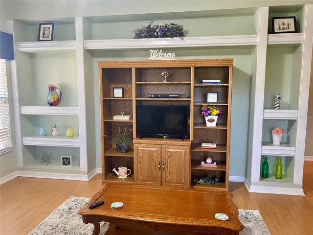 Custom built in shelving wall with entertainment center and smart tv
