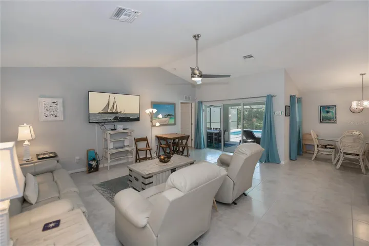 Open floor plan. Triple sliders open to the pool deck & lanai.