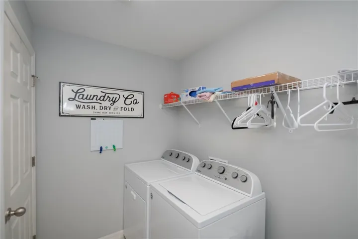 Utility room with storage closet, opens to the attached garage.