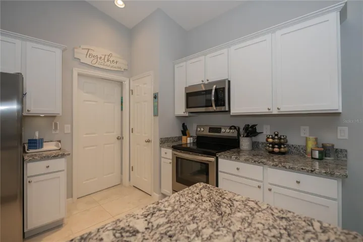 Kitchen closet pantry and door to the utility room.