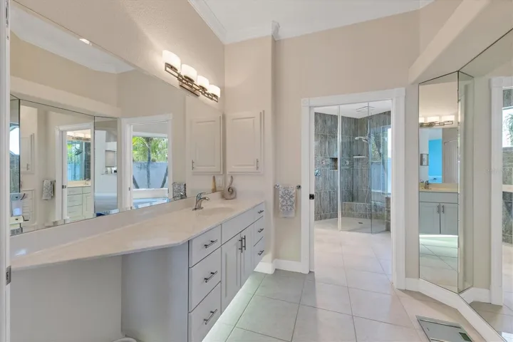 Primary Suite dressing room with entry into the shower and bathroom
