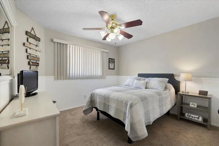 Upstairs Bedroom remodeled with fresh paint, wainscoting and chair rail moulding