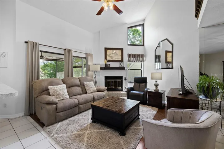 Living room with vaulted ceilings and woodburning fireplace
