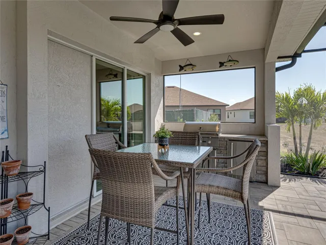 Expanded, screened veranda with outdoor kitchen