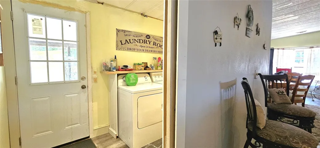 Inside laundry room includes side by side washer & dryer
