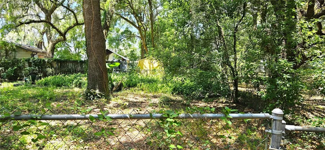 Fenced backyard, above ground pool, wood deck, screened in lanai