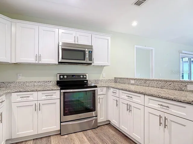 Kitchen view 2:Breakfast bar, vinyl flooring, stainless steel appliances, Granite counters, soft close cabintes recessed lighting