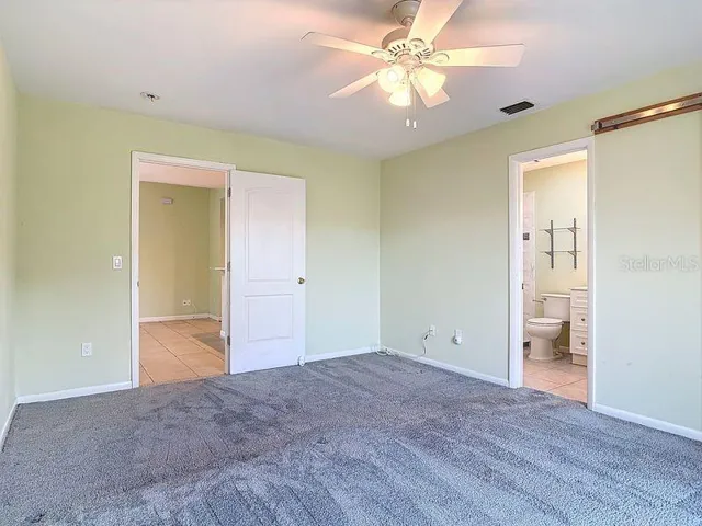 Primary bedroom with ensuite bathroom- Walk in closet with barn style door