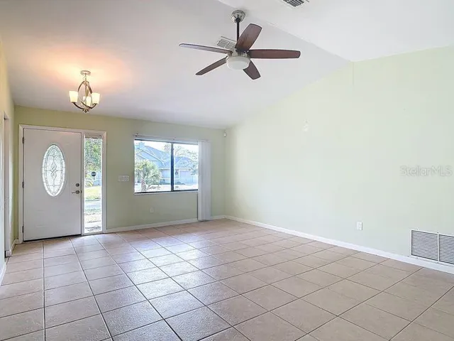 Dining room view to Living room to entranceway. Leaded glass front door with sidelight and large picture window