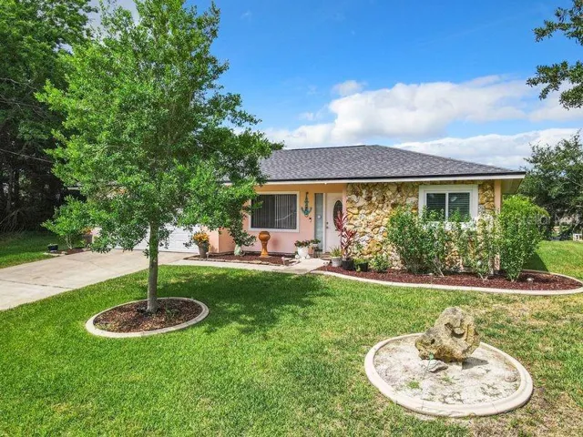 Front view- curb edging and mature trees, sprinkler system