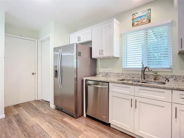 Kitchen view toward laundry room and garage
