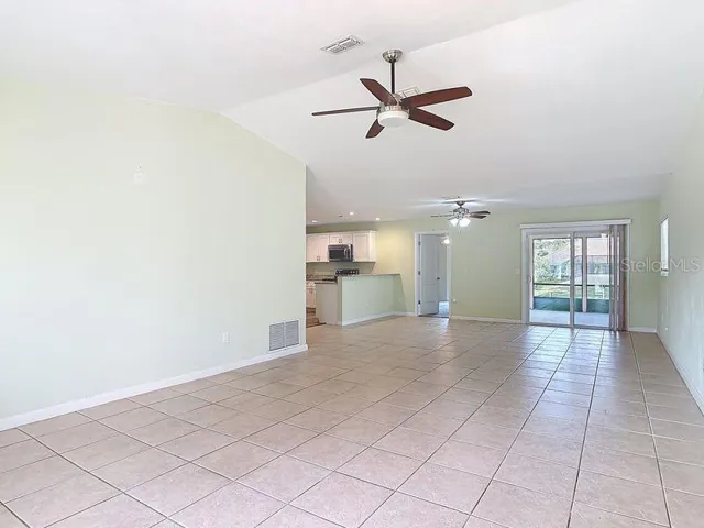 View From entrance -Open and bright floor plan-Living Room view to Dining Room and Sliders to Lanai