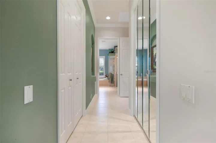 Hallway to en-suite primary bathroom has two walk-in closets