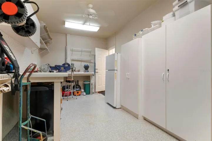 3rd one car garage with built-in storage, workbench and a wall separating from abutting 2 car garage, expoxy finish floor