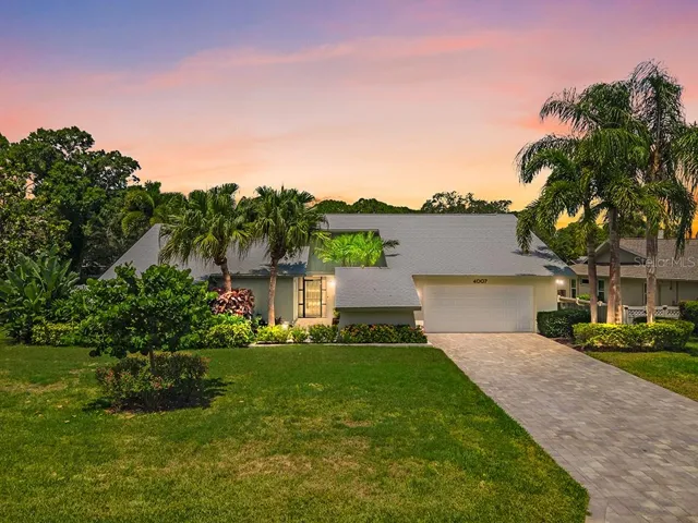 Front view with paver driveway and walkway to Lead Glass Entry Door.  Beautiful sunsets poolside