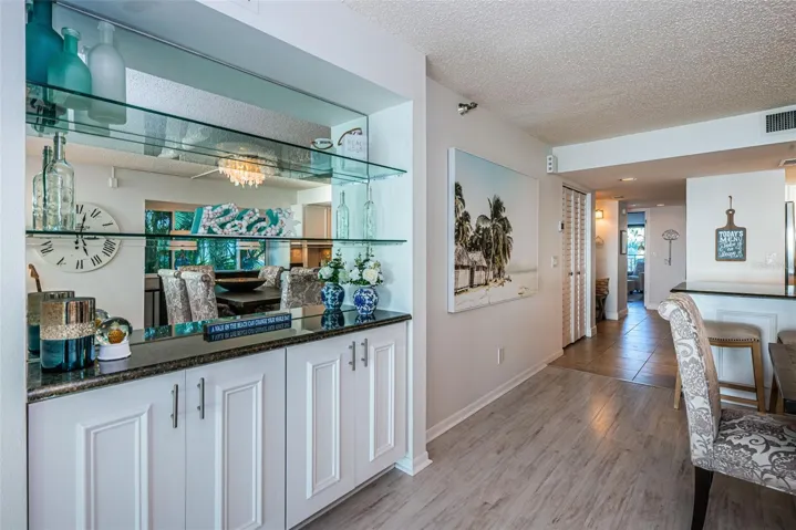 .. Dry Bar with View of Hallway Towards Both Guest Bedrooms - Guest Bath - Entrance & Additional Storage Closets.