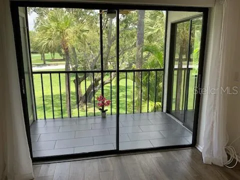 Living room view out to screened balcony