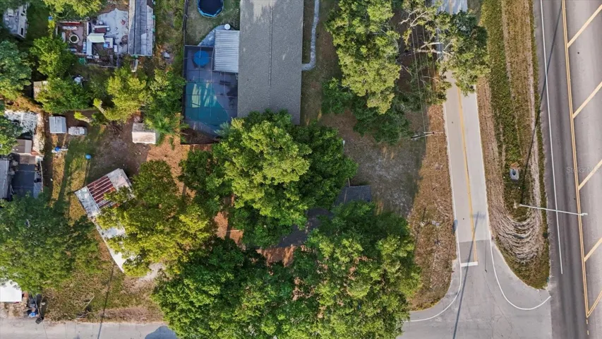 Big house is under the the shady canopy. The older structure is to the left in this picuture. This is a double lot on a corner and on a Cul de Sac street.