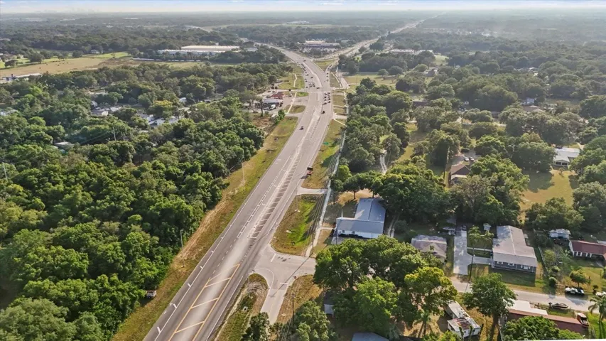 Home is in the bottom right at the corner in this picture. The main house is under the shade canopy. The older storage only mobile home is seen to it's right. You can see the intersection of E Fowler Ave and 301 at the top.