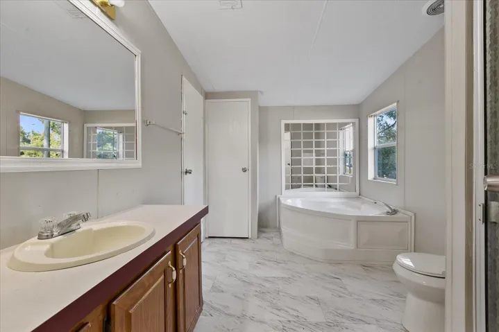 Primary ensuite bathroom with soaker tub and separate shower.