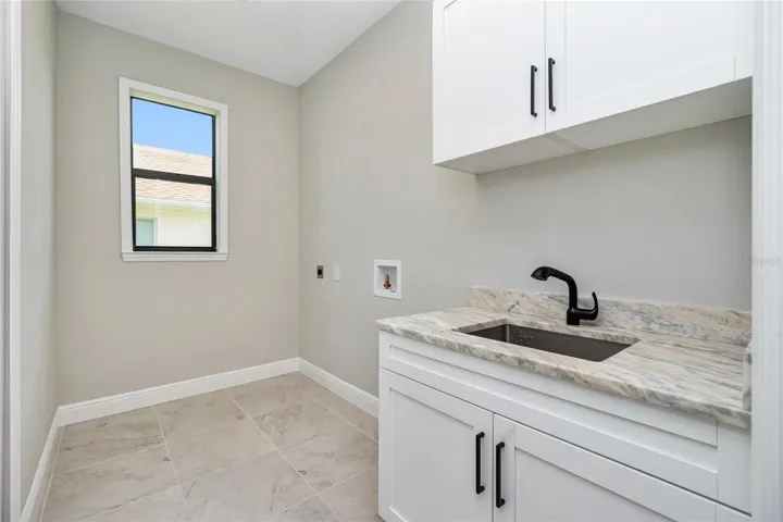 Laundry room with cabinets and sink!