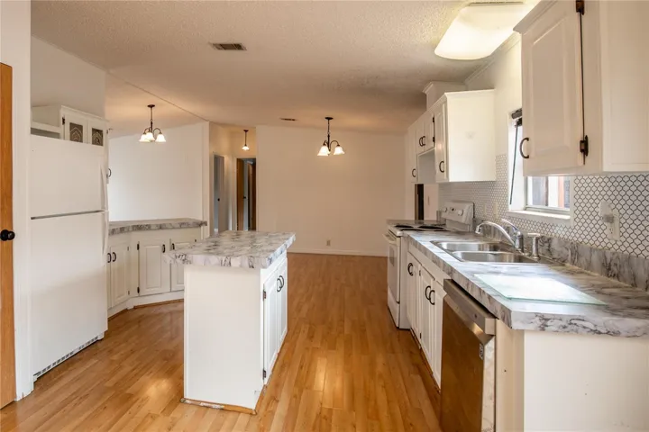 An island kitchen opens to both dining and family rooms.