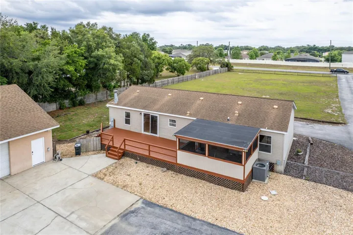 A large back deck and screened lanai are located on the real of the home.