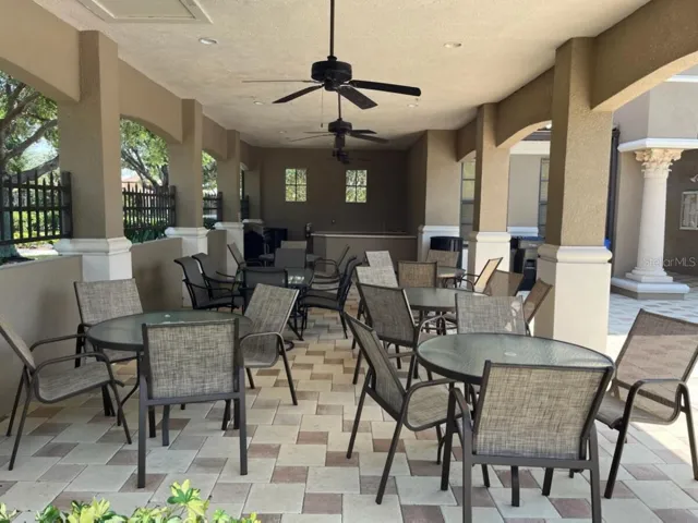 Community gathering area with sink and grill by the pool.
