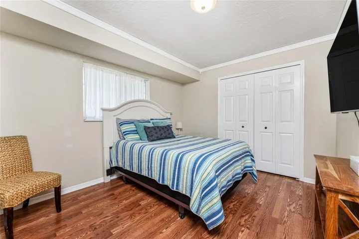 Bedroom 2 Has Wood Laminate Flooring And A Wall Closet.