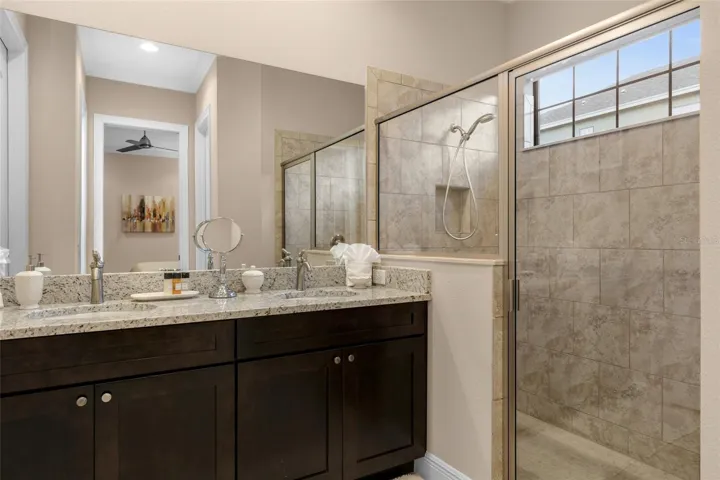 Primary bathroom level 1 with dual sink and walk in shower