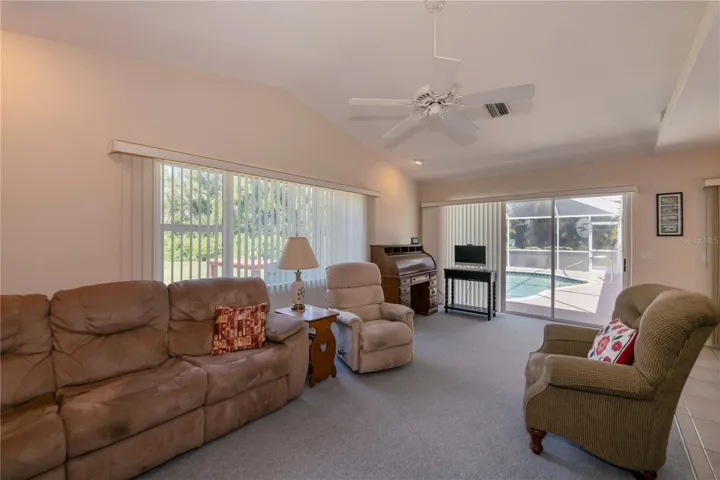 cathedral ceiling family room opens to the pool & lanai