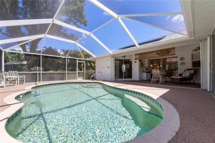 inviting pool with Florida screen lanai and accordion hurricane shutters