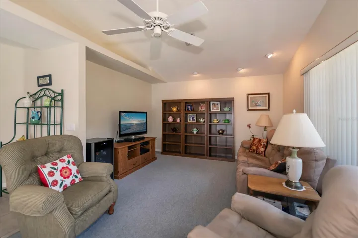 sizable family room with cathedral ceiling and plant shelf
