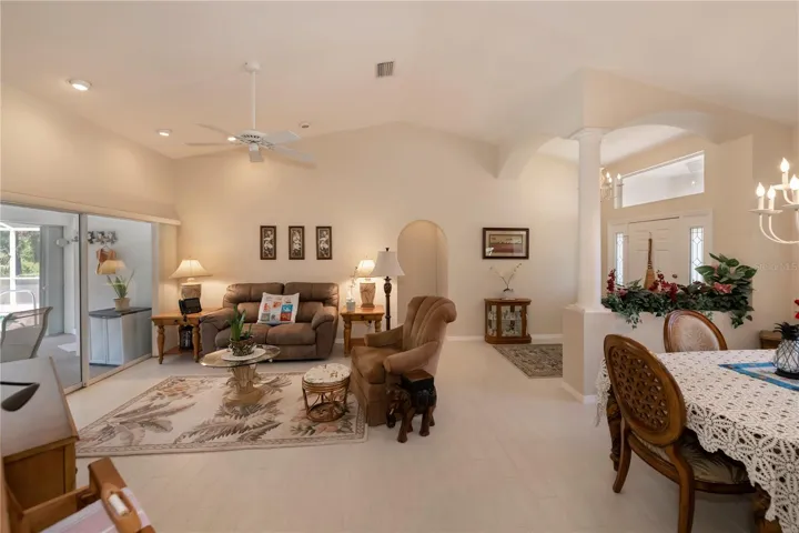 cathedral ceiling living room with sliders to the pool & lanai