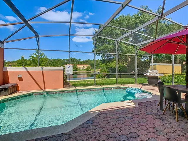 Relax and unwind in your own private oasis, overlooking the serene lake. Enjoy poolside dining under the shade of your red umbrella, perfect for those sunny Florida afternoons. Welcome to your new vacation home at 3179 Yellow Lantana Ln!