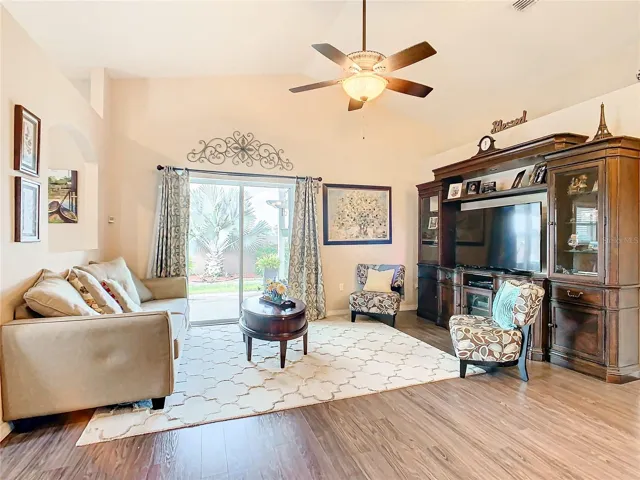 Living room with sliding glass doors that open to the back yard pergola.