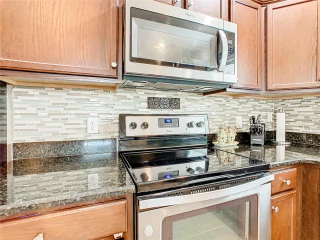 Tile backsplash compliments the granite countertops.