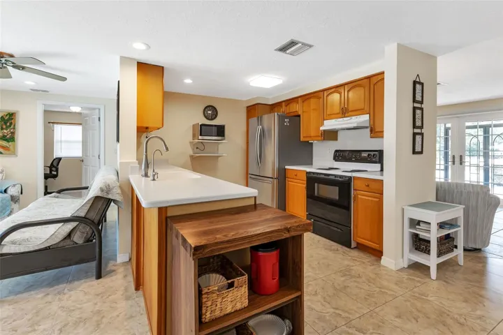 Kitchen with appliances and solid surface countertops.