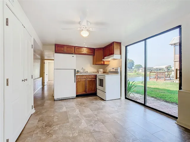 Two lighted ceiling fans are in the living room and the sliding glass doors provide a nice view of the waterfront.