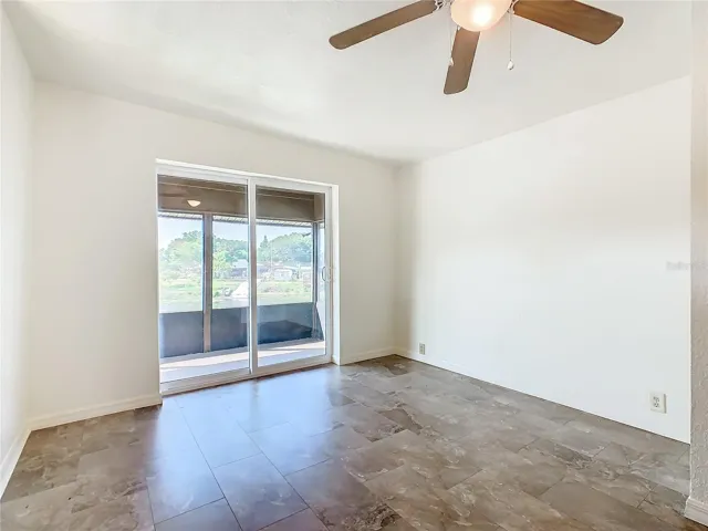 Kitchen, living room and sliding glass doors leading to the screened porch.