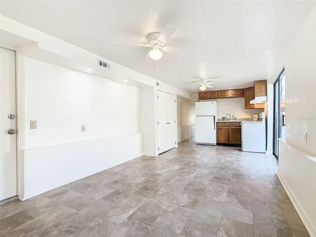 Living room looking to the kitchen.  The entry door is visible at the left-front view of this picture.
