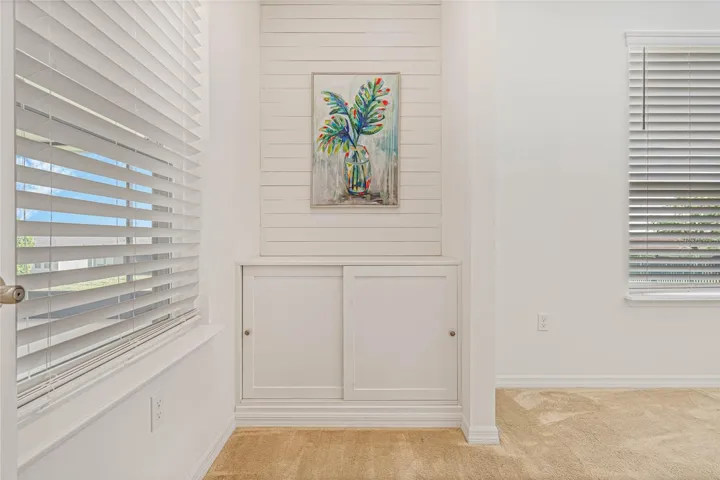 PRIMARY SUITE ENTRY HAS SHIPLAP ACCENT WALL & BUILT IN STORAGE