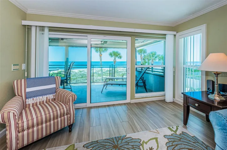 ... Looking West or out to  26' x 10' Balcony.. New-  High Impact Sliders - New Curtains - New Elec Storm Shutters..