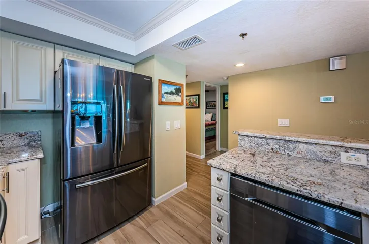 ... Kitchen Looking Towards Guest Bedroom Suite & Entry Doorway. Guest Bathroom with Laundry Next to Guest Bedroom. 3rd Bedroom behind Kitchen Refrigerator Wall.. New Flooring Thru- Out Unit ..