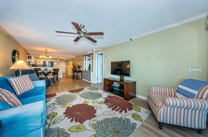 .. Looking In From the Living Room Balcony Towards 31' x 13' Great Room. New Flooring - New Wall Finish- New Lighting.. Open White Door to Master Suite on Right Side by TV..